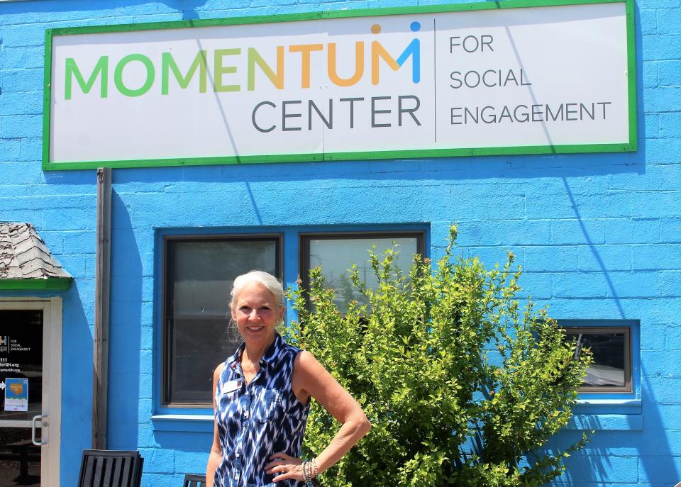 Momentum Center Experi-Mentor Barbara Lee VanHorssen stands in front the the organization's Grand Haven location Tuesday, May 30, 2023.