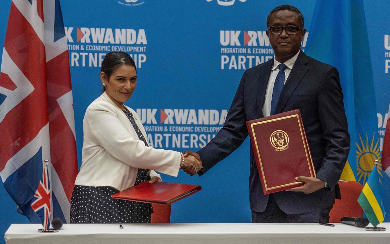 Priti Patel (L), and Rwandan Minister of Foreign Affairs and International Cooperation Vincent Biruta, shake hands after signing an agreement including a controversial deal saying that asylum seekers arriving in the UK would be sent to Rwanda, at Kigali Convention Center, Kigali, Rwanda on April 14, 2022