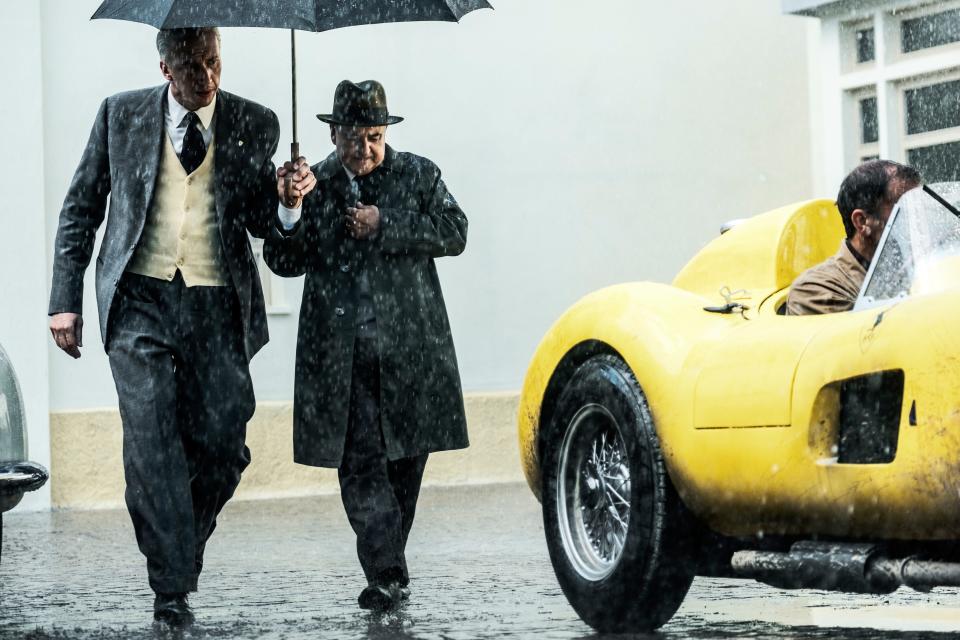 Adam Driver (left) plays Enzo Ferrari in "Ferrari," which focuses on a tense time in 1957 when the famous automaker was having financial and marital problems.