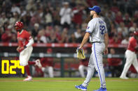Los Angeles Angels' Jo Adell, left, scores on a walk Cole Tucker as Kansas City Royals starting pitcher Michael Wacha stands by during the seventh inning of a baseball game Thursday, May 9, 2024, in Anaheim, Calif. (AP Photo/Mark J. Terrill)