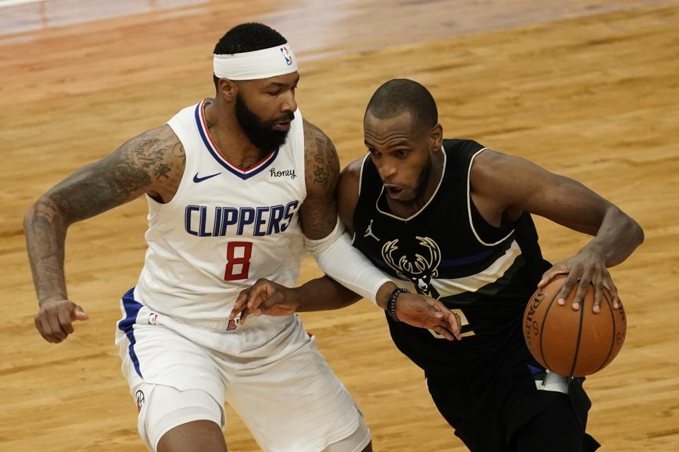 Milwaukee Bucks' Khris Middleton drives past LA Clippers' Marcus Morris Sr. during the second half of an NBA basketball game Sunday, Feb. 28, 2021, in Milwaukee. (AP Photo/Morry Gash)