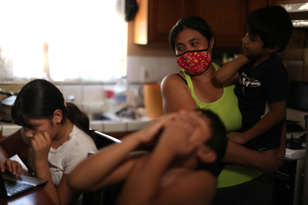 Los Angeles Unified School District students work on school-issued computers at their home. (Lucy Nicholson/Reuters)