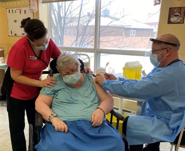 Nicole Laplante, centre, receives a dose of a COVID-19 vaccine in Embrun, Ont., Jan. 13, 2021.