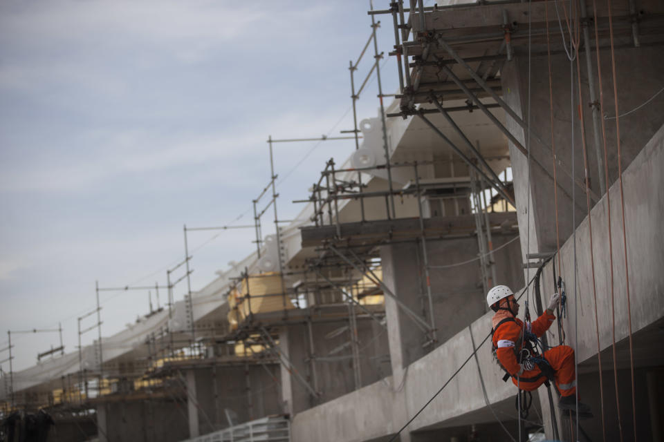 A construction worker trains rappelling in preparation for the installation of the new rooftop of the the Maracana soccer stadium in Rio de Janeiro, Brazil, Thursday, Nov. 8, 2012. Brazil was granted permission by FIFA on Thursday to host the Confederations Cup with six venues including Rio de Janeiro, Salvador, Recife, Brasilia, Belo Horizonte and Fortaleza, as originally planned. FIFA had previously announced the six cities as hosts, but said Recife and Salvador would only be ratified if they showed significant improvement in their preparations. (AP Photo/Felipe Dana)