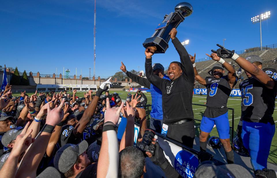 Buffalo head coach Maurice Linguist lifts the Camellia Bowl Trophy in front of his team after they defeated Georgia Southern in the Camellia Bowl held at Cramton Bowl in Montgomery, Ala., on Tuesday December 27, 2022. Credit: Mickey Welsh / Advertiser-USA TODAY NETWORK
