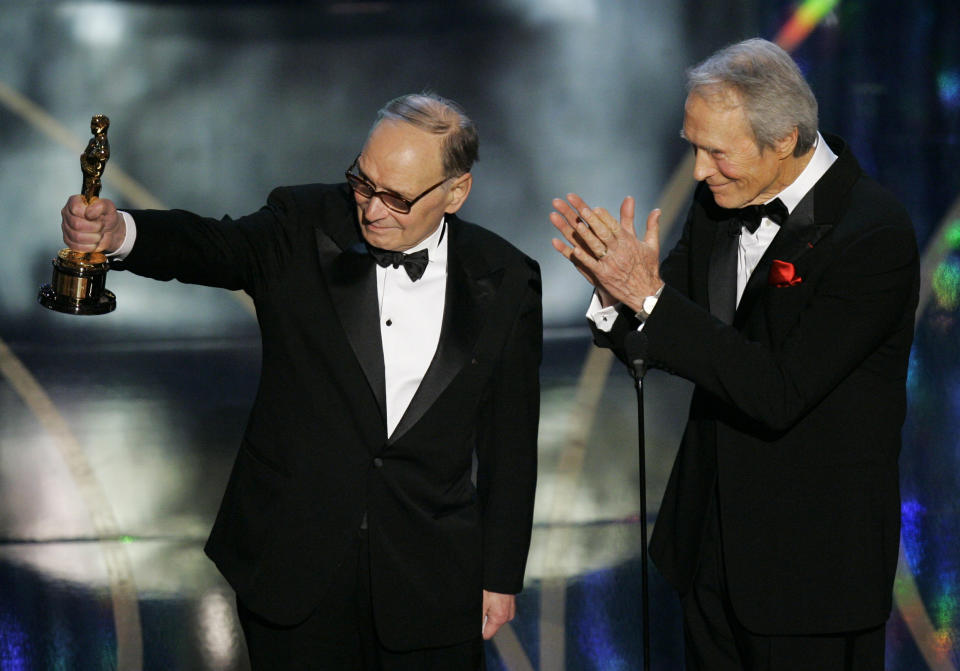 ** EMBARGOED AT THE REQUEST OF THE ACADEMY OF MOTION PICTURE ARTS AND SCIENCES FOR USE UPON CONCLUSION OF THE ACADEMY AWARDS TELECAST **  Italian composer Ennio Morricone, left, accepts an honorary Oscar for his contributions to the art of film music from presenter Clint Eastwood during the 79th Academy Awards telecast Sunday, Feb. 25, 2007, in Los Angeles. (AP Photo/Mark J. Terrill)