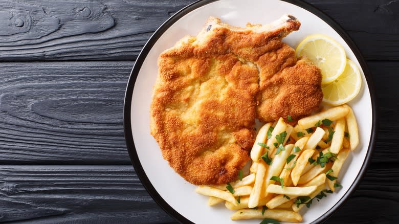 Breaded meat with fries