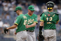 Oakland Athletics manager Bob Melvin, center, relieves relief pitcher Burch Smith (46) in the seventh inning of a baseball game against the New York Yankees, Saturday, June 19, 2021, in New York. (AP Photo/John Minchillo)