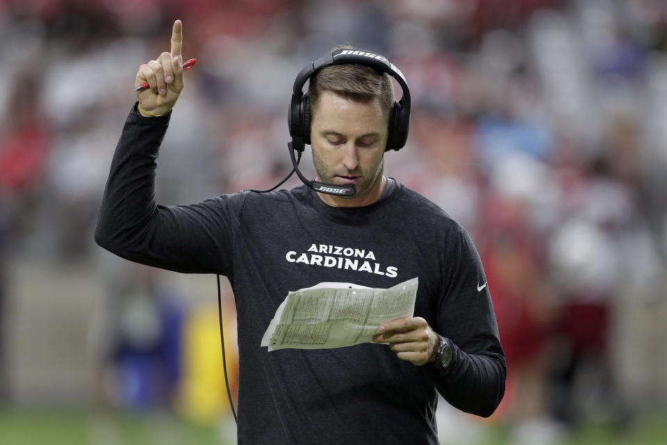 Arizona Cardinals head coach Kliff Kingsbury makes a call during the teams' NFL football training camp, Thursday, July 25, 2019, in Glendale, Ariz. (AP Photo/Matt York)