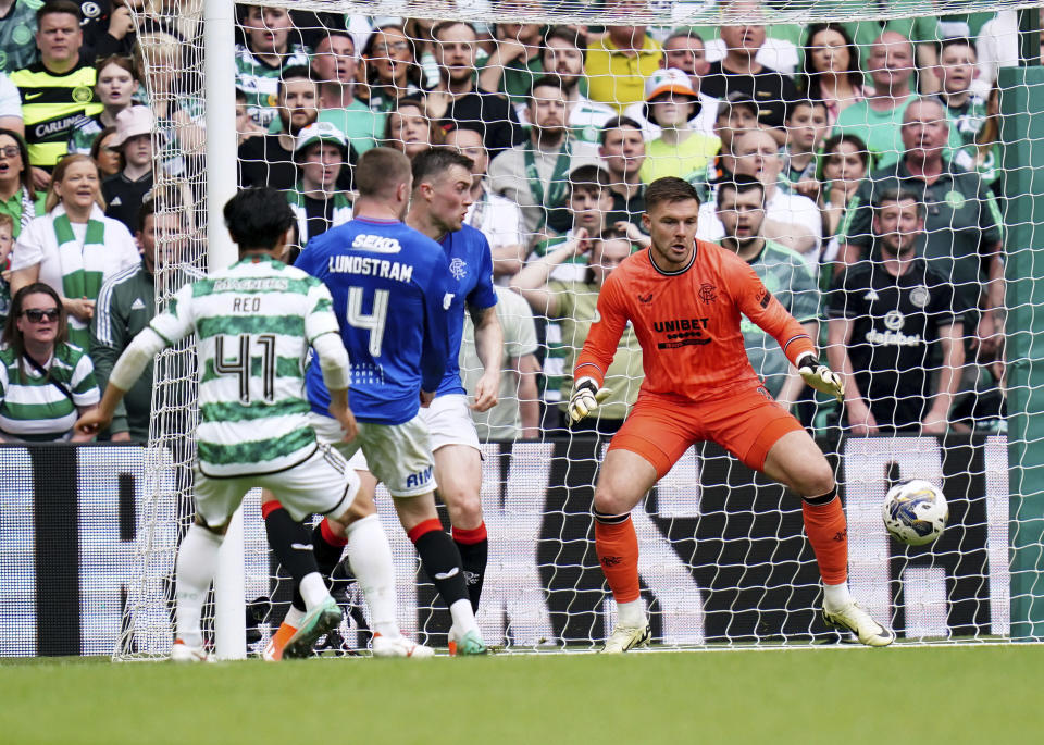 Rangers' John Lundstram scores an own goal, during the Scottish Premiership soccer match between Glasgow Rangers and Celtic Glasgow, at the Celtic Park, in Glasgow, Scotland, Saturday May 11, 2024. (Jane Barlow/PA via AP)