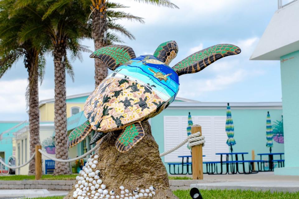 colorful painted sea turtle sculpture in front of a store on south padre island