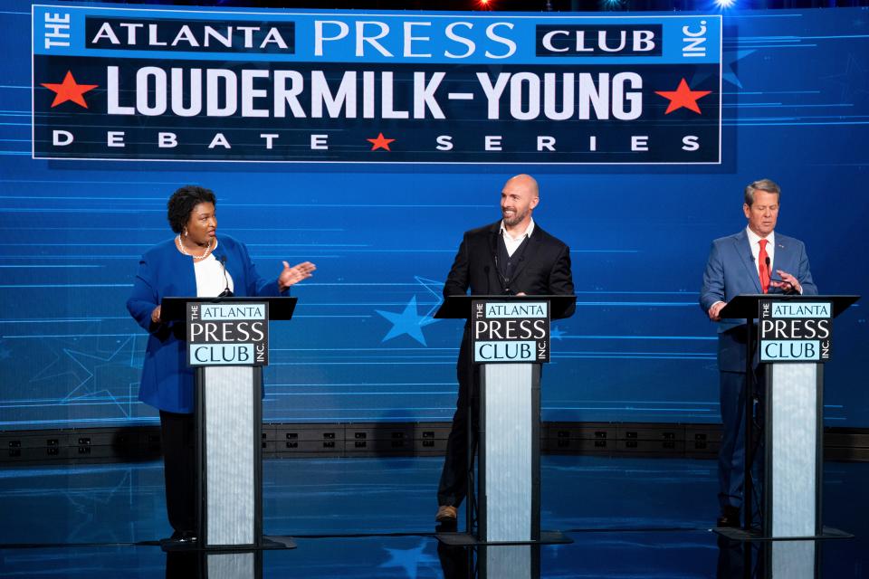 Democratic challenger Stacey Abrams, Libertarian Shane Hazel and Georgia Republican Gov. Brian Kemp square off on stage Monday night in Atlanta.