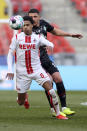 Cologne's Ismail Jakobs, left, and Bremen's Milo Veljkovic, right, challenge for the ball during the German Bundesliga soccer match between 1. FC Cologne and Werder Bremen in Cologne, Germany, Sunday, March 7, 2021. (Rolf Vennenbernd/dpa via AP)