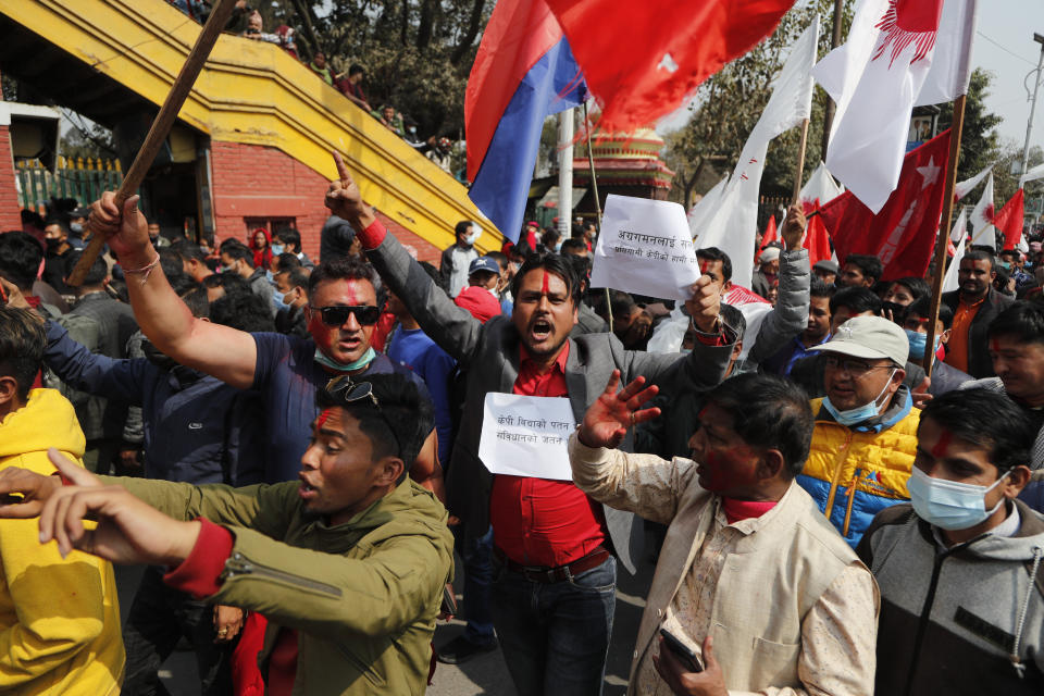 Nepalese supporters of a splinter group in the governing Nepal Communist Party participate in a rally to celebrate the Supreme Court order in Kathmandu, Nepal, Wednesday, Feb. 24, 2021. Nepal's Supreme Court on Tuesday ordered the reinstatement of Parliament after it was dissolved by the prime minister, in a ruling likely to thrust the Himalayan nation into a political crisis. (AP Photo/Niranjan Shrestha)