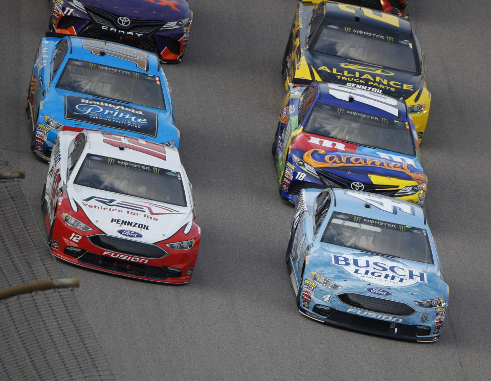 Kevin Harvick (4) leads the pack during the NASCAR Cup Series auto race at Kansas Speedway on Saturday, May 12, 2018, in Kansas City, Kan. (AP Photo/Charlie Riedel)