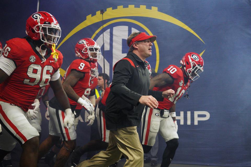 Dec 3, 2022; Atlanta, GA, USA; Georgia Bulldogs head coach Kirby Smart leads his team onto the field prior to the SEC Championship game against the LSU Tigers at Mercedes-Benz Stadium. Mandatory Credit: Brett Davis-USA TODAY Sports