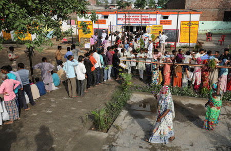 Voters line up to cast their votes outside a polling station during the second phase of general election in Amroha, in the northern Indian state of Uttar Pradesh, India, April 18, 2019. REUTERS/Anushree Fadnavis