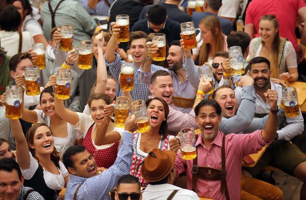 Revelers cheer with 1-liter-mugs of beer during the opening weekend of the 2019 Oktoberfest on September 21, 2019 in Munich, Germany.  (Photo: Johannes Simon via Getty Images)
