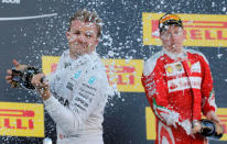 Formula One - Russian Grand Prix - Sochi, Russia - 1/5/16 - Winner Mercedes F1 driver Nico Rosberg of Germany and third placed Ferrari driver Kimi Raikkonen of Finland spray champagne after the Russian Grand Prix. REUTERS/Maxim Shemetov