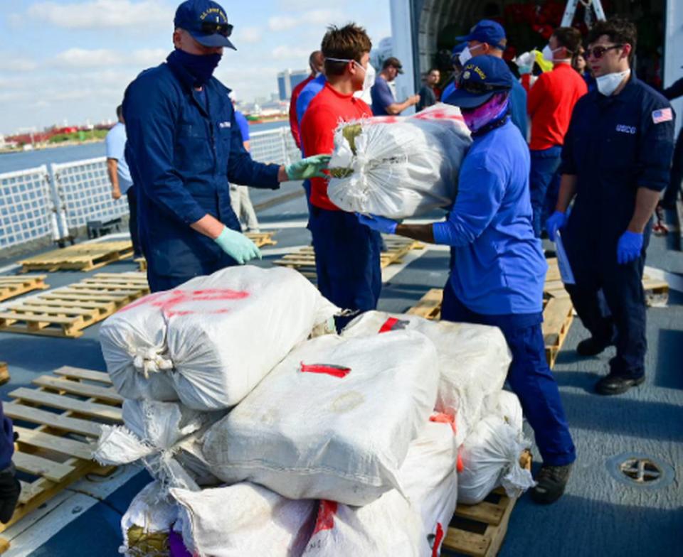 U.S. Coast Guard members on the cutter Mohawk stack drugs on the deck at Port Everglades in Fort Lauderdale Friday, May 10, 2024. The cocaine and marijuana were seized during the Mohawk’s deployment in the Caribbean and Atlantic Ocean.