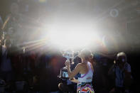 Aryna Sabalenka of Belarus kisses the Daphne Akhurst Memorial Trophy after defeating Elena Rybakina of Kazakhstan in the women's singles final during the women's singles final at the Australian Open tennis championship in Melbourne, Australia, Saturday, Jan. 28, 2023. (AP Photo/Asanka Brendon Ratnayake)