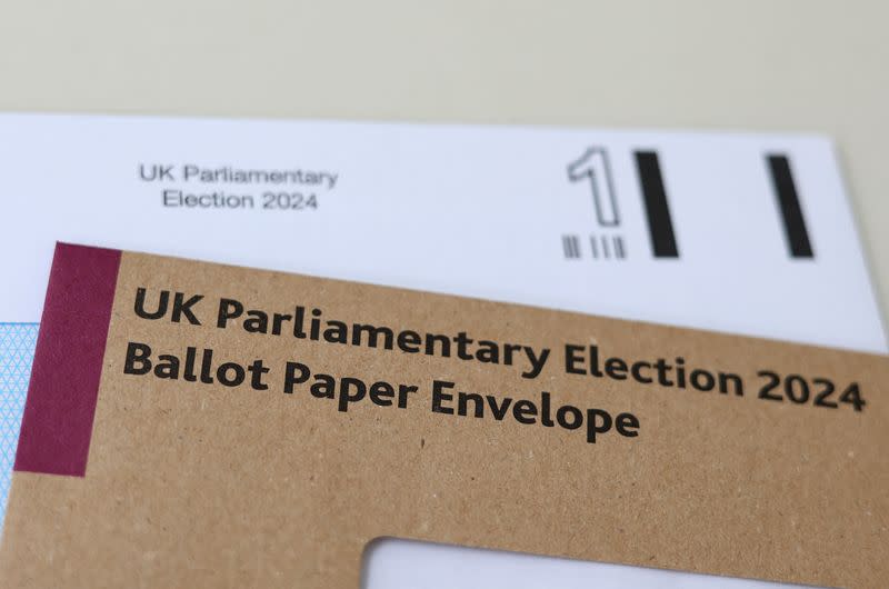 Photo illustration shows details of postal voting materials for Britain's 2024 parliamentary election