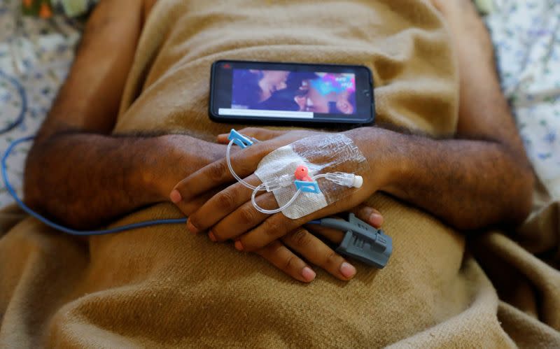 Medical workers take care of patients suffering from the coronavirus disease (COVID-19), at a hospital in Noida