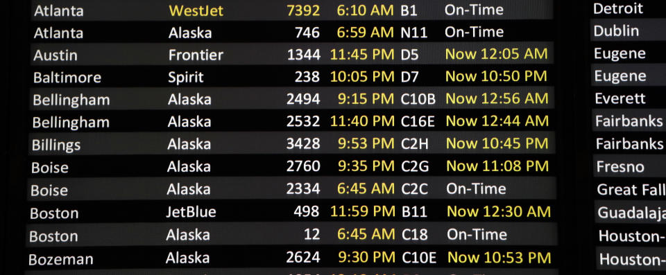 A reader board shows a number of flights delayed at Sea-Tac International Airport Friday, Aug. 10, 2018, in SeaTac, Wash. An airline mechanic stole an Alaska Airlines plane without any passengers and took off from Sea-Tac International Airport in Washington state on Friday night before crashing near Ketron Island, officials said. (AP Photo/Elaine Thompson)