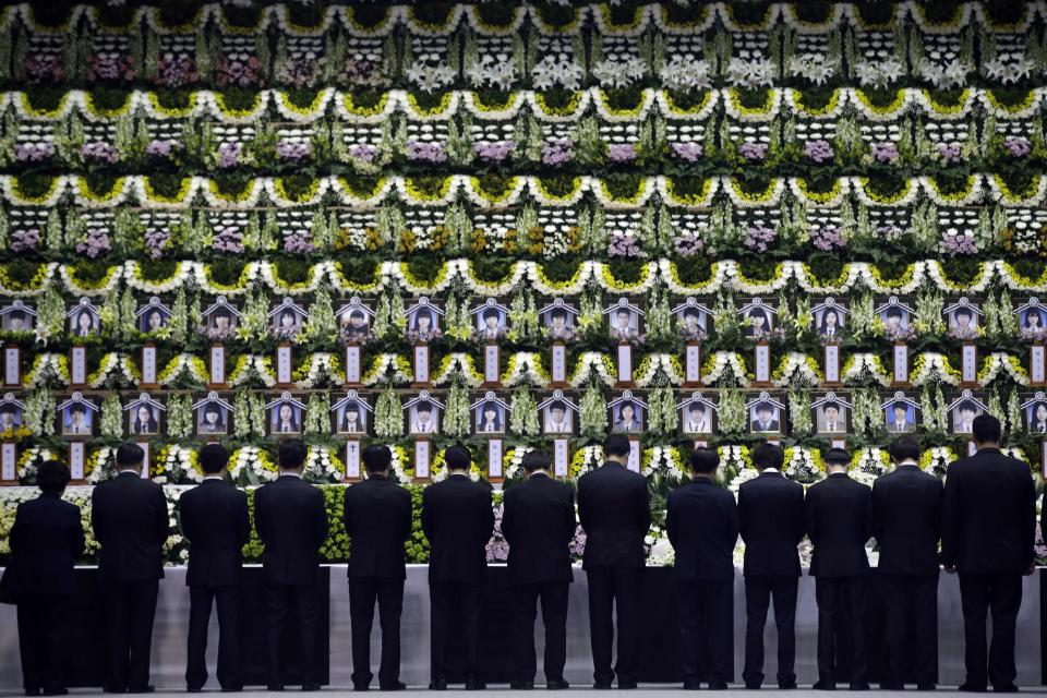 Mourners pay tribute to the victims of the sunken ferry Sewol during a temporary memorial at the auditorium of the Olympic Memorial Museum in Ansan, south of Seoul, South Korea, Thursday, April 24, 2014. Jokes and concerts are out. So are school field trips and boisterous cheering at baseball games. As South Korea mourns one of its worst ever disasters, a ferry sinking on April 16 that will likely result in the death of more than 300 people, most of them high school kids, anything deemed frivolous or fun is frowned upon, and the backlash for breaking this collective somber mood can be harsh. (AP Photo/Lee Jin-man)