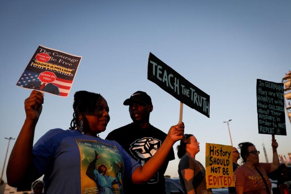 <div class="inline-image__caption"><p>People hold signs during a gathering outside a Books-a-Million bookstore where Florida Governor Ron DeSantis signed copies of his book "The Courage to Be Free" in Leesburg, Florida.</p></div> <div class="inline-image__credit">Marco Bello/Reuters</div>