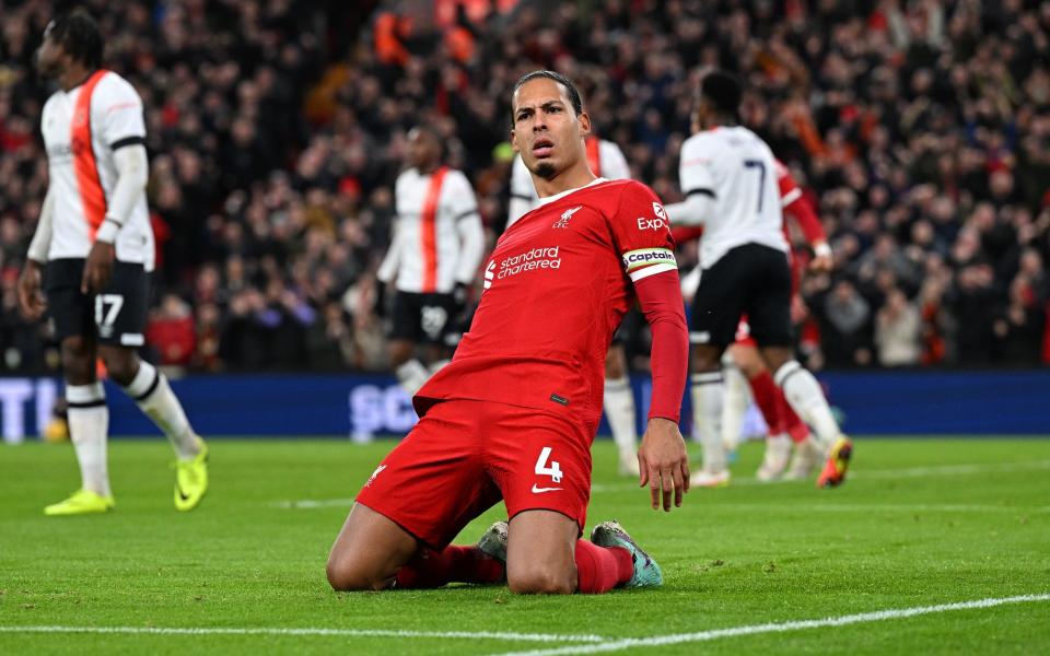 Virgil van Dijk captain of Liverpool celebrates after scoring the first Liverpool goal during the Premier League match between Liverpool FC and Luton Town at Anfield on February 21, 2024 in Liverpool, England.