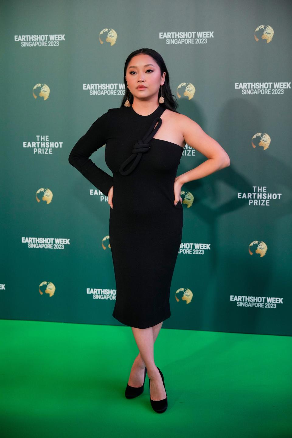 Lana Condor poses for photographer on the green carpet for the Earthshot Prize Awards.