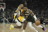 Milwaukee Bucks' Damian Lillard gets past Indiana Pacers' Aaron Nesmith during the first half of Game 1 of the NBA playoff basketball game Sunday, April 21, 2024, in Milwaukee. (AP Photo/Morry Gash)