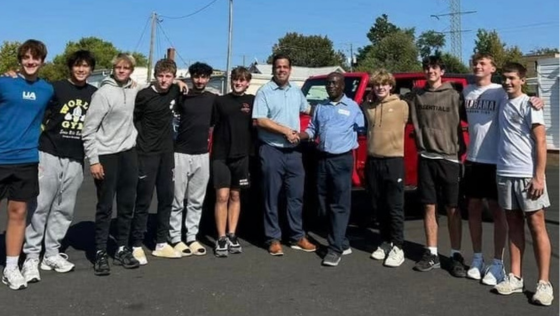 Francis Apraku (fifth from right) stands with students | Bennett Hibshman