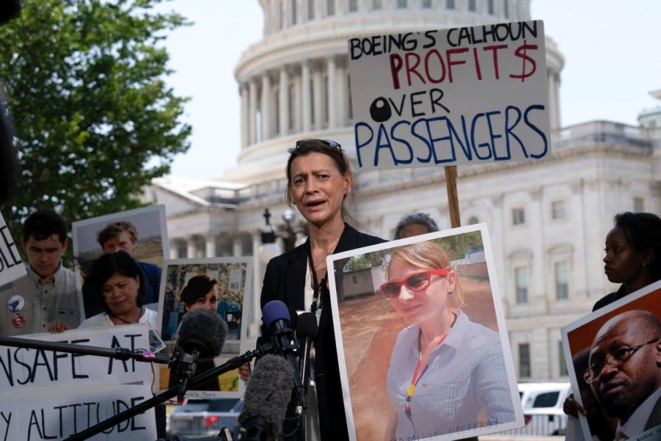 Family members of crash victims attended the hearing, many carrying pictures of their loved ones (AP)