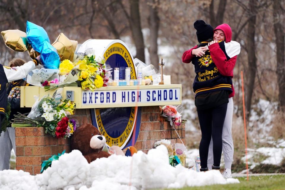 FILE - Students hug at a memorial at Oxford High School in Oxford, Mich., Dec. 1, 2021. (Copyright 2021 The Associated Press. All rights reserved)