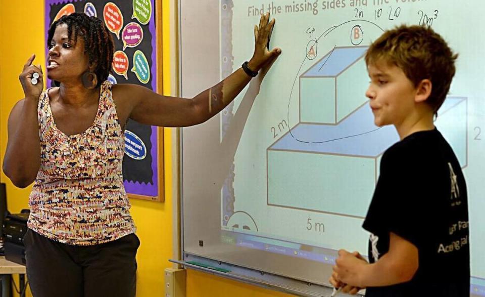 Fifth grade teacher Tawauna Stewart, 50, and student Matthew Degele, 10, discuss a math problem involving volume at Pearsontown Elementary School in Durham, N.C. Wednesday, August 12, 2015.