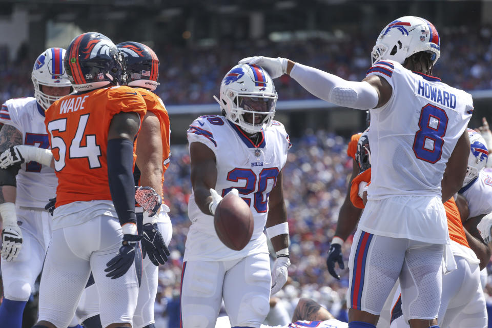 Buffalo Bills' Zack Moss, center, celebrates a touchdown during the first half of a preseason NFL football game against the Denver Broncos, Saturday, Aug. 20, 2022, in Orchard Park, N.Y. (AP Photo/Joshua Bessex)