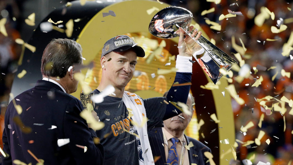 Denver Broncos' Peyton Manning (18) holds up the trophy after the NFL Super Bowl 50 football game, in Santa Clara, Calif.