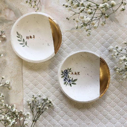 two personalized ring dishes on table