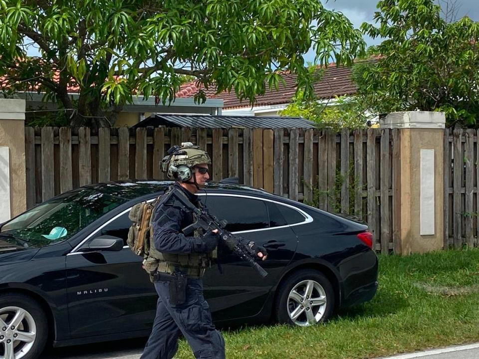 A member of Miami-Dade Police Department’s Special Response Team walks down Southwest 172nd Street holding a semiautomatic rife Friday, Oct. 27, 2023.