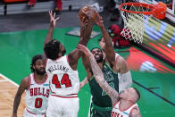 Chicago Bulls forward Patrick Williams, left, battles for a rebound against Boston Celtics center Tristan Thompson, right, during the first half of an NBA basketball game, Monday, April 19, 2021, in Boston. (AP Photo/Charles Krupa)