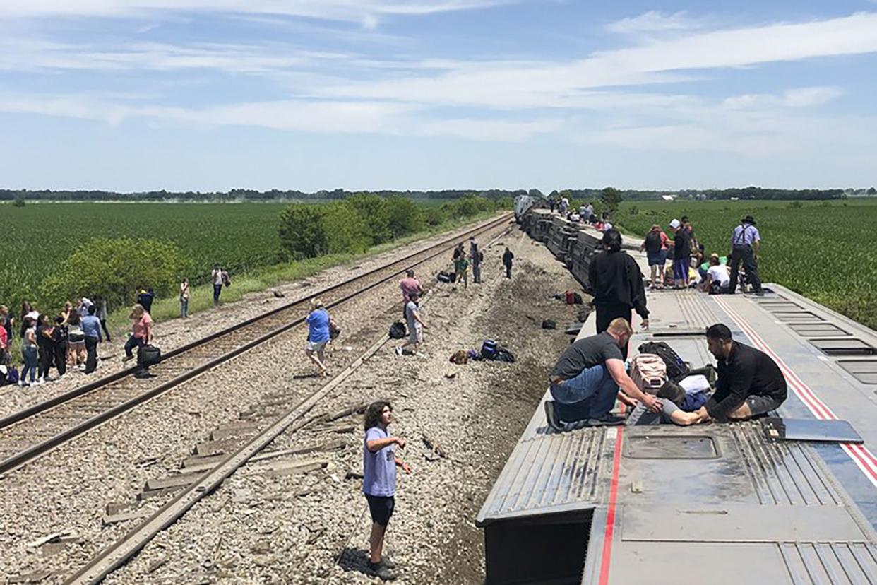 An Amtrak passenger train lies on its side after derailing near Mendon, Mo., on Monday.