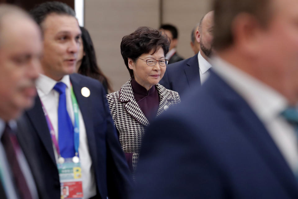 Hong Kong Chief Executive is Carrie Lam, center, arrives for the second Hongqiao International Economic Forum of the 2nd China International Import Expo at the National Exhibition and Convention Center in Shanghai, China, Tuesday, Nov. 5, 2019. (Wu Hong/Pool Photo via AP)