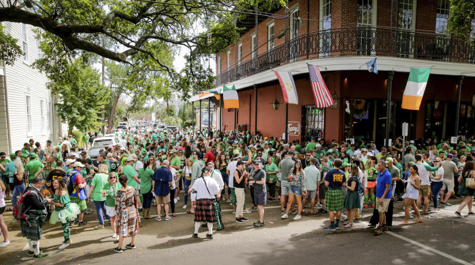 Revelers celebrate St. Patrick's Day Saturday, March 14, 2020, during an unofficial gathering at Tracey's Original Irish Channel Bar in New Orleans. (Scott Threlkeld/The Advocate via AP)