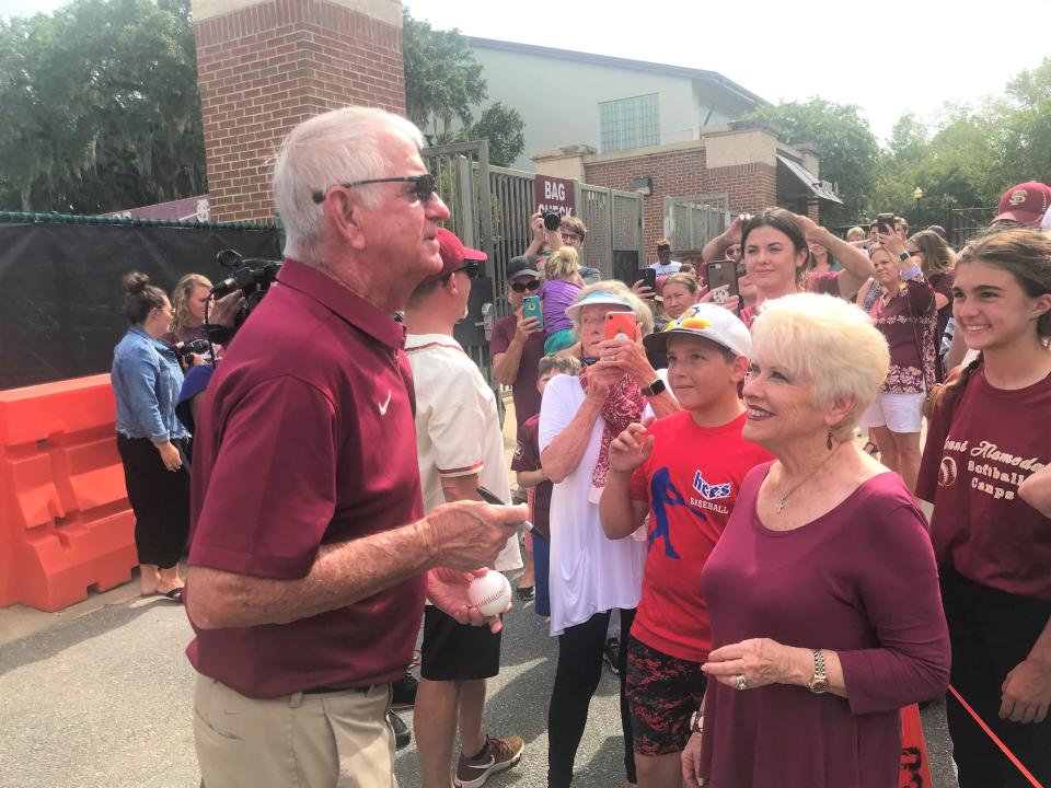 Florida State baseball head coach Mike Martin signs an autograph alongside his wife Carol during a fan rally at Dick Howser Stadium on Thursday, June 20, 2019.