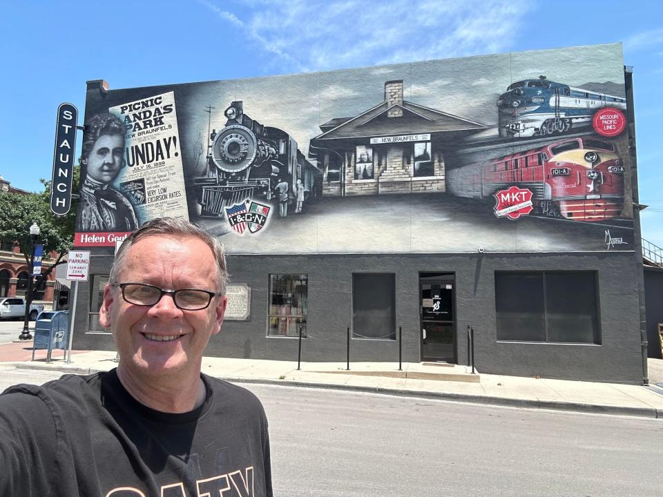 Eric Newland in front of a train Mural near New Braunfels' Train Museum.