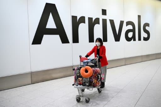 Face masks are being used as a frontline defense in China and around the world against the deadly coronavirus -- here, a passenger is seen arriving at London's Heathrow airport