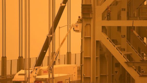 PHOTO: Workmen tend to the George Washington Bridge, as seen from Fort Lee, N.J., as haze from wildfires in Canada settles over the area on June 7, 2023. (Seth Wenig/AP)