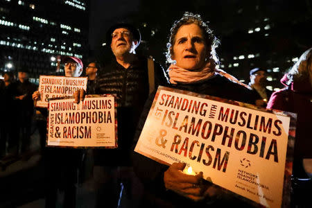 People gather for a candlelight vigil for victims of the pickup truck attack at Foley Square in New York City, U.S., November 1, 2017. REUTERS/Jeenah Moon